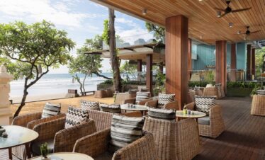 Beachfront seating at Maya Sanur Resort with tropical views and cozy chairs