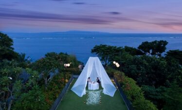 Romantic dining setup at Maya Sanur Resort overlooking the ocean at sunset