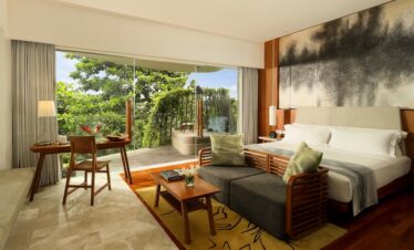Spacious room at Maya Sanur Resort with modern decor and tropical views