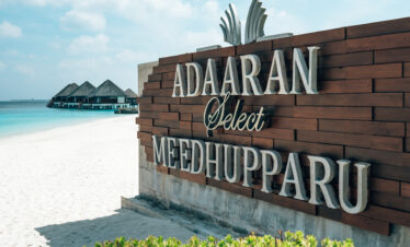 Adaaran Meedhupparu resort entrance sign on sandy beach