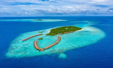Aerial view of Ayada Maldives with overwater villas stretching out into the ocean