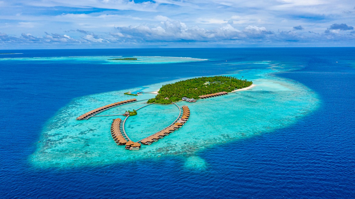 Aerial view of Ayada Maldives with overwater villas stretching out into the ocean
