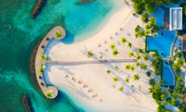 Aerial view of Dhigali beach and boardwalk surrounded by turquoise waters