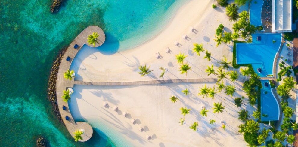 Aerial view of Dhigali beach and boardwalk surrounded by turquoise waters
