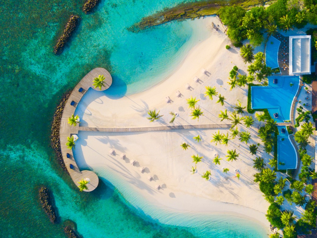 Aerial view of Dhigali beach and boardwalk surrounded by turquoise waters