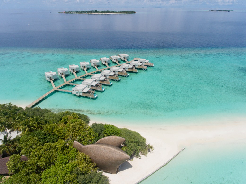 Aerial view of Dhigali overwater villas and turquoise lagoon