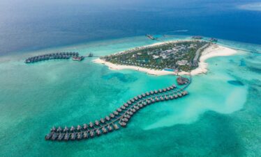 Aerial view of Heritance Aarah resort surrounded by crystal clear ocean and sandy beaches