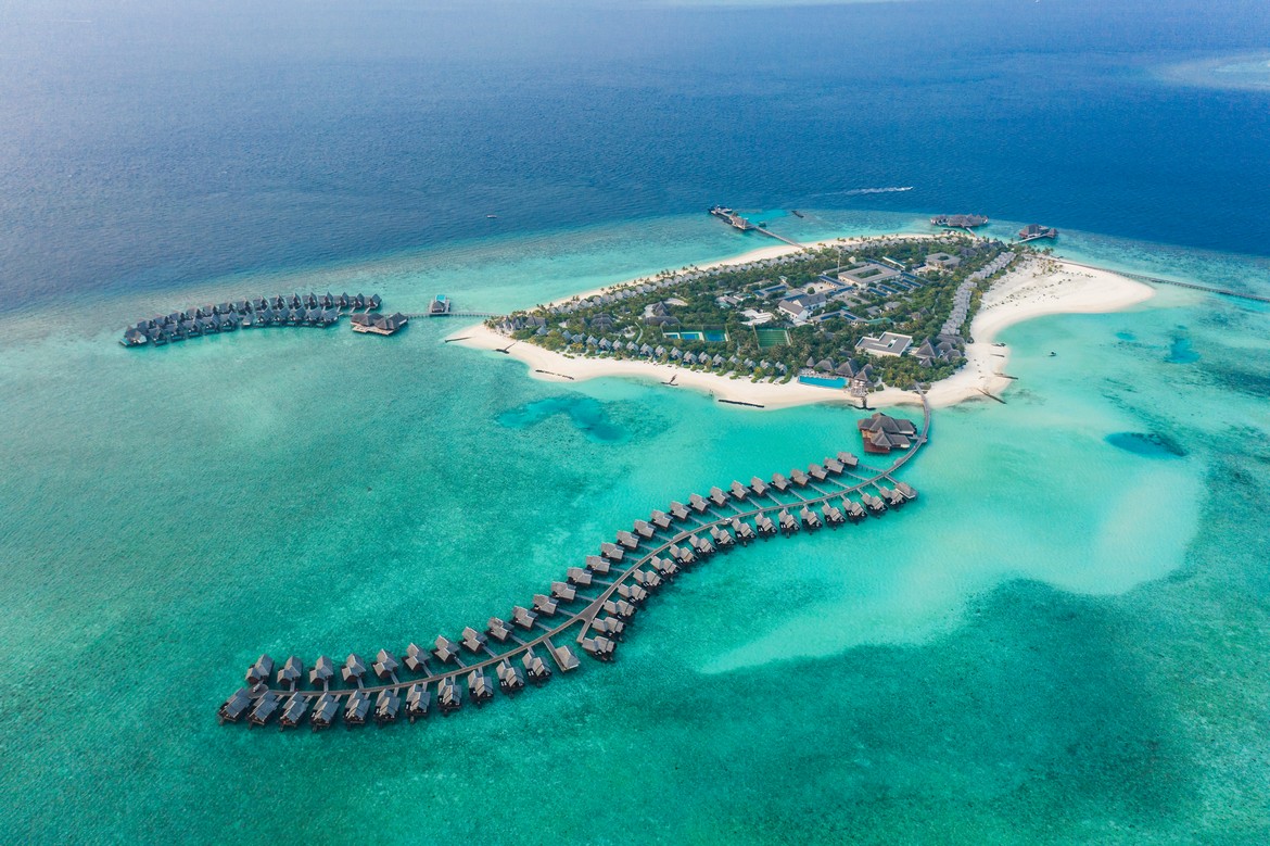 Aerial view of Heritance Aarah resort surrounded by crystal clear ocean and sandy beaches