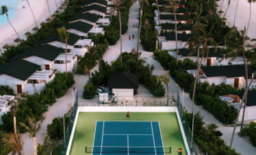 Aerial view of Joy Island tennis court and beachfront villas