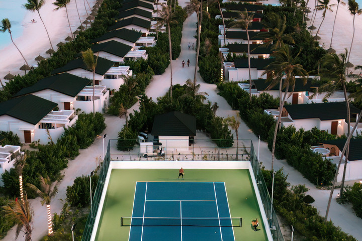 Aerial view of Joy Island tennis court and beachfront villas
