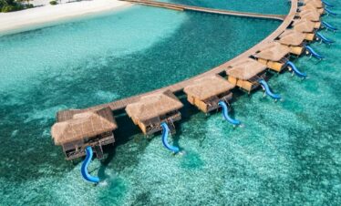Aerial view of You and Me by Cocoon overwater villas with slides into the ocean