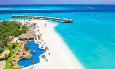 Aerial view of You and Me by Cocoon resort with turquoise water and beach villas