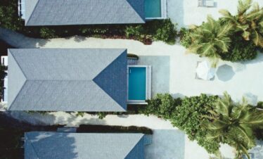 Aerial view of villas at Jawakara Dheru Island with private pools and lush surroundings