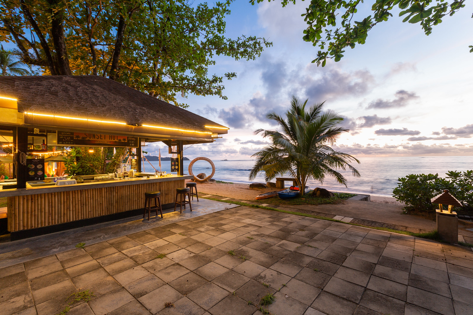 Beachfront bar at Khao Lak Merlin with a view of the sunset over the ocean