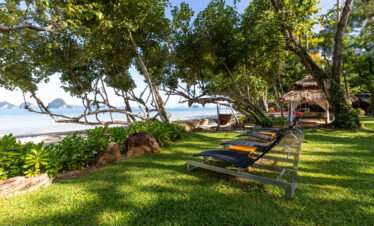 Beachfront garden area with loungers and views of the sea at The Tubkaak Krabi