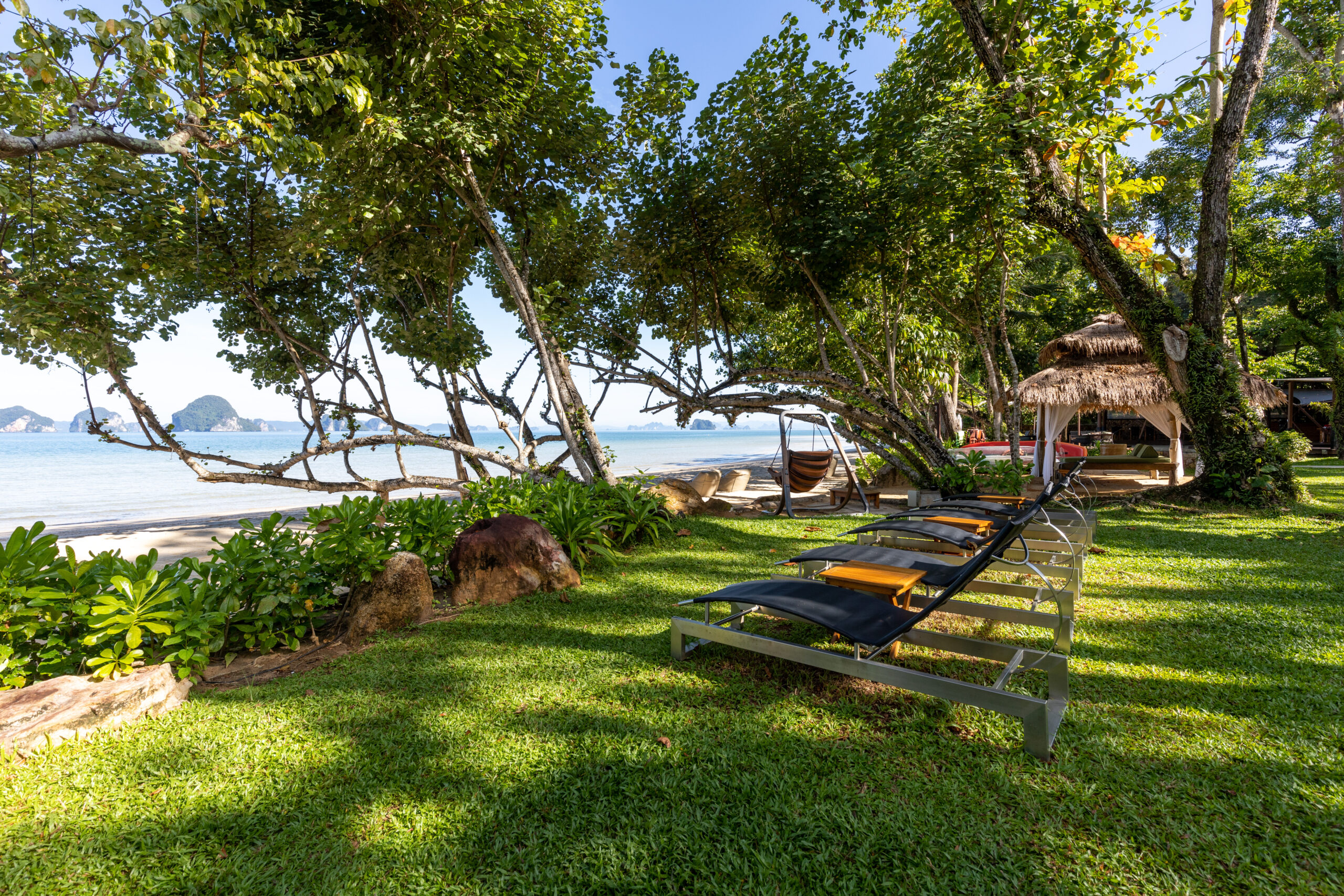 Beachfront garden area with loungers and views of the sea at The Tubkaak Krabi