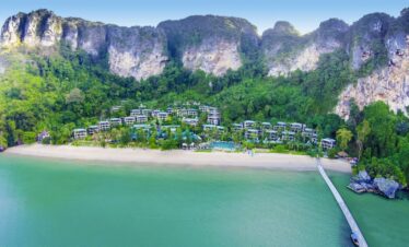 Beachfront of Centara Grand Beach Resort with lush greenery and mountains
