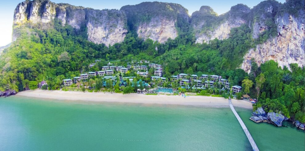 Beachfront of Centara Grand Beach Resort with lush greenery and mountains