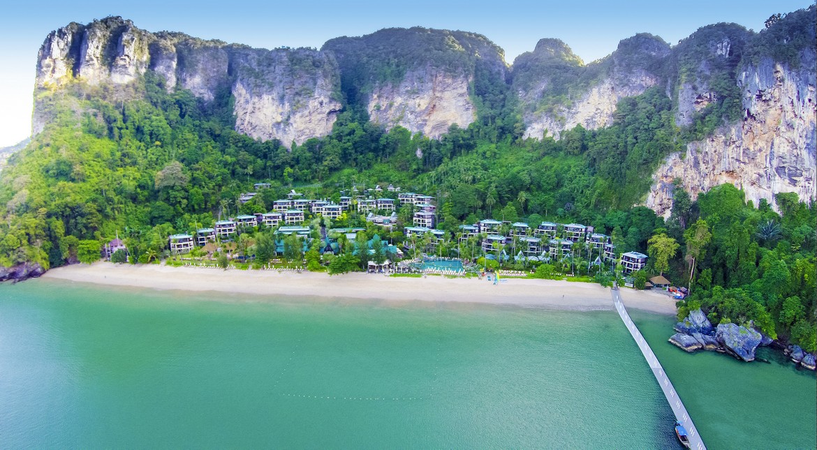 Beachfront of Centara Grand Beach Resort with lush greenery and mountains