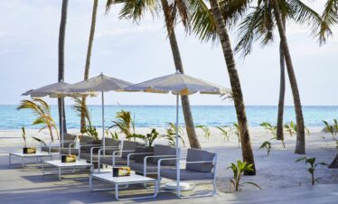 Beachfront seating area with umbrellas at Riu Palace