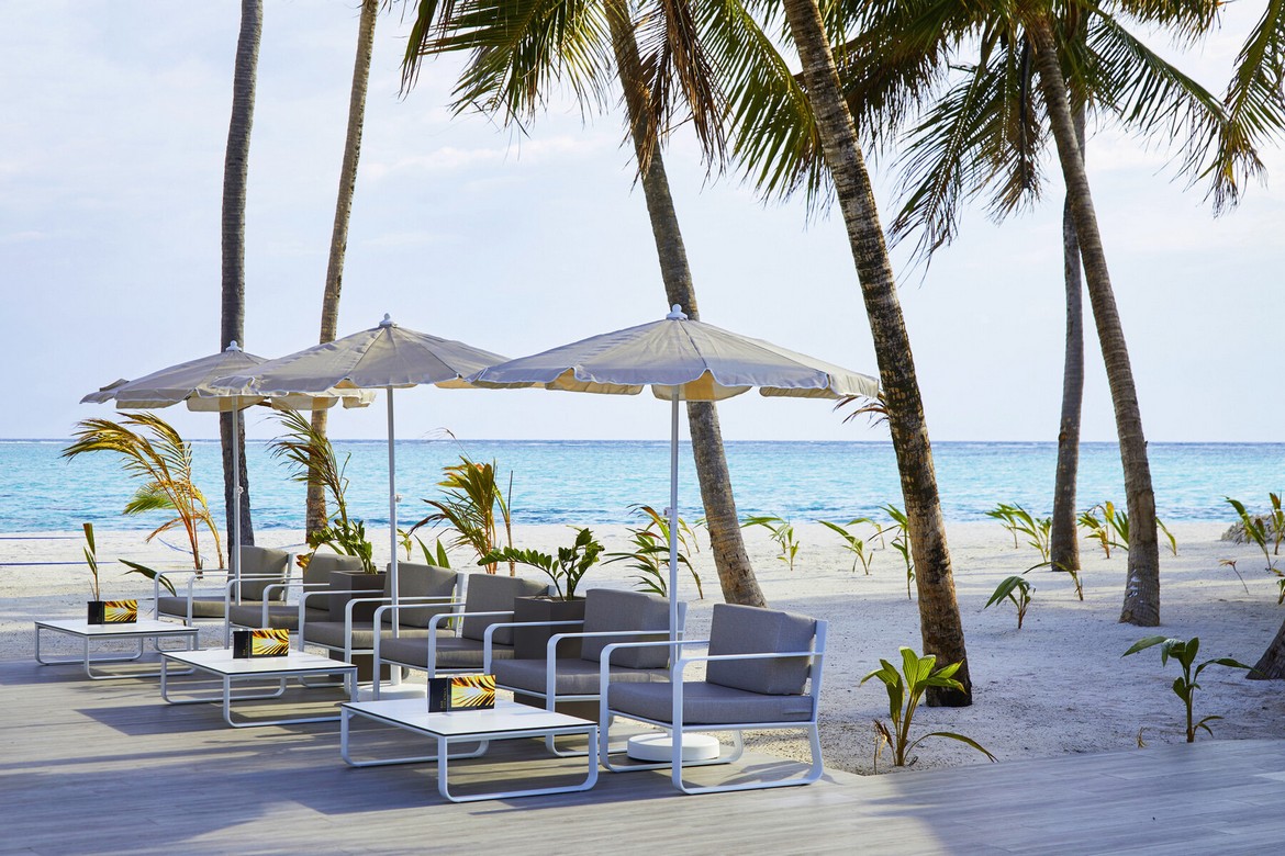 Beachfront seating area with umbrellas at Riu Palace