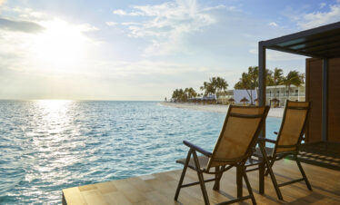 Beachfront view with sun loungers overlooking the ocean at Riu Atoll