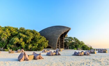 Bean bags on the beach near Dhigali resort_s unique thatched structure