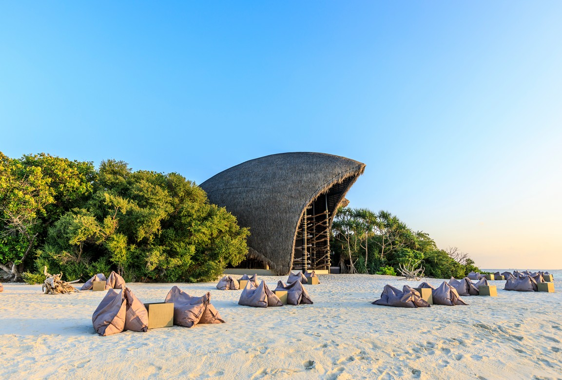 Bean bags on the beach near Dhigali resort_s unique thatched structure