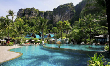 Beautiful pool surrounded by lush greenery at Centara Grand Beach Resort