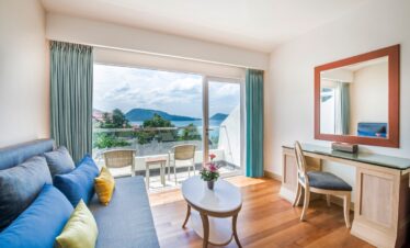 Bright and airy living area with ocean view from a balcony at Diamond Cliff Resort