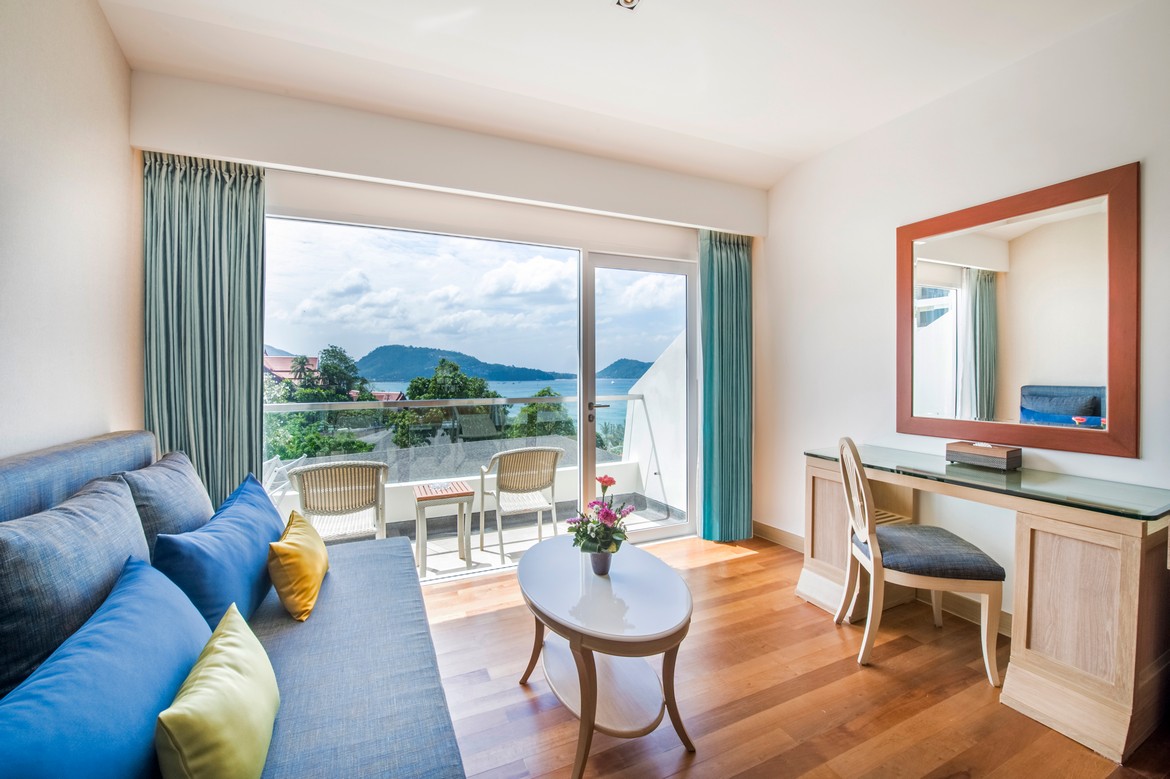 Bright and airy living area with ocean view from a balcony at Diamond Cliff Resort