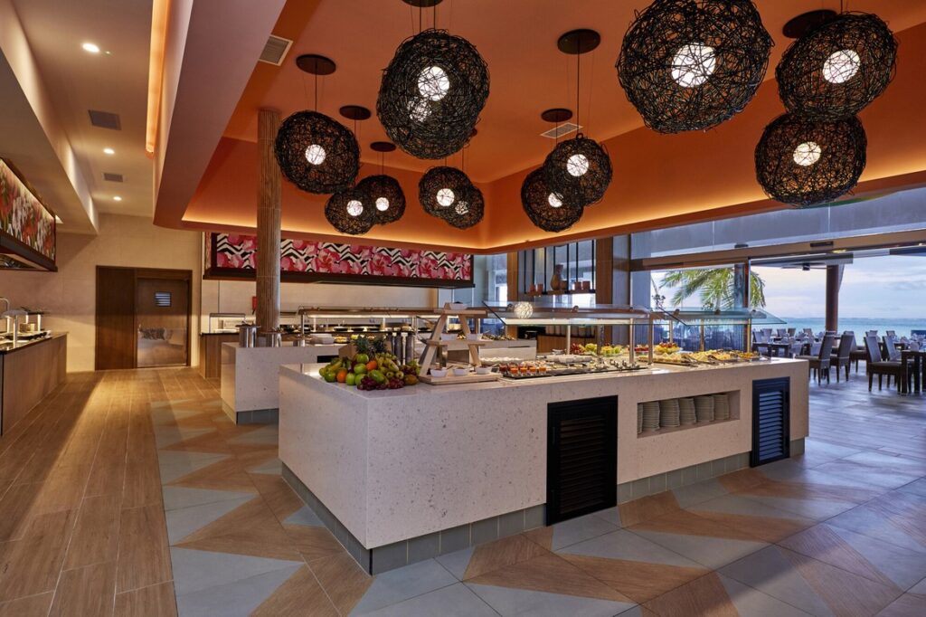 Buffet area with a variety of dishes under stylish lighting at Riu Atoll