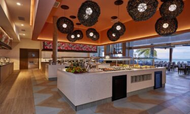 Buffet area with a variety of dishes under stylish lighting at Riu Atoll