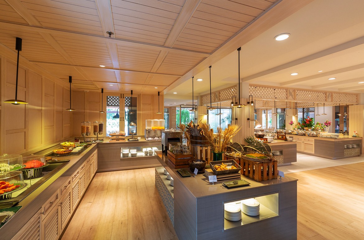 Buffet setup at Khao Lak Merlin with a variety of food and bright interior lighting