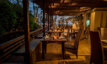 Candlelit dining area at Centara Grand Beach Resort with a view of the ocean