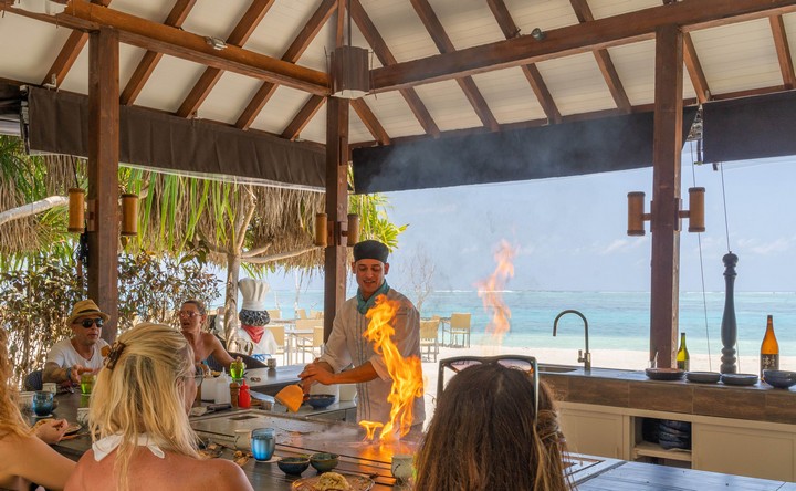 Chef cooking with fire at You and Me by Cocoon resort restaurant by the beach