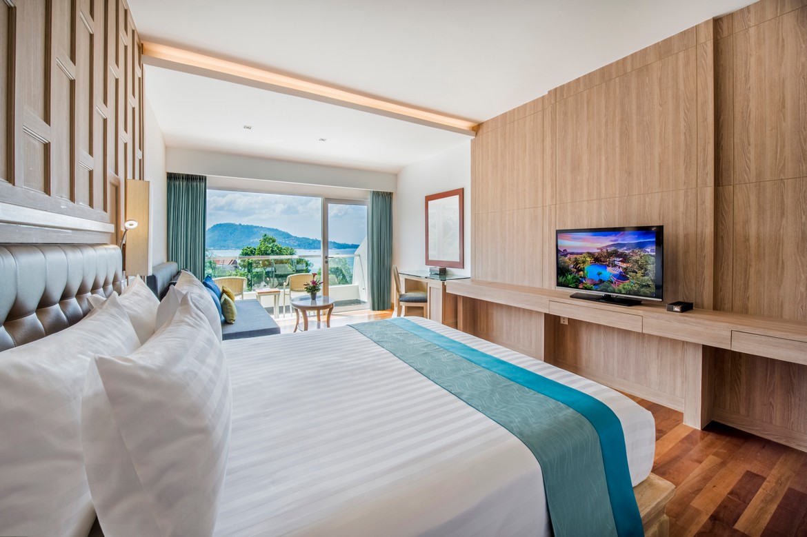Comfortable bedroom with a scenic ocean view at Diamond Cliff Resort