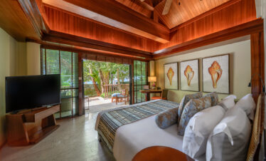 Cozy bed and decor in a room at Centara Grand Beach Resort