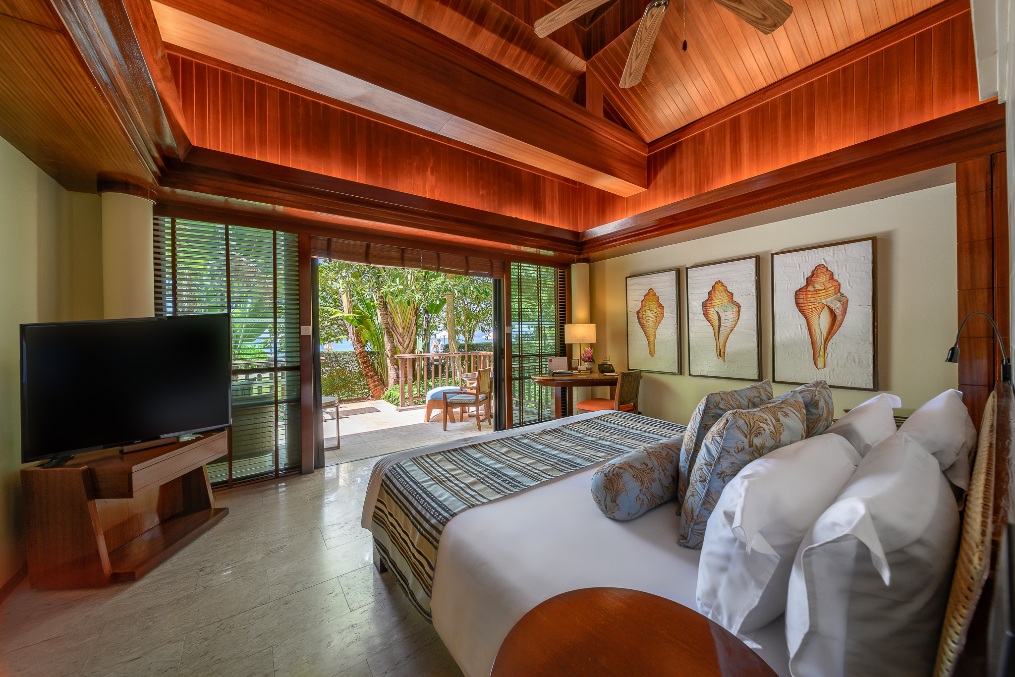 Cozy bed and decor in a room at Centara Grand Beach Resort