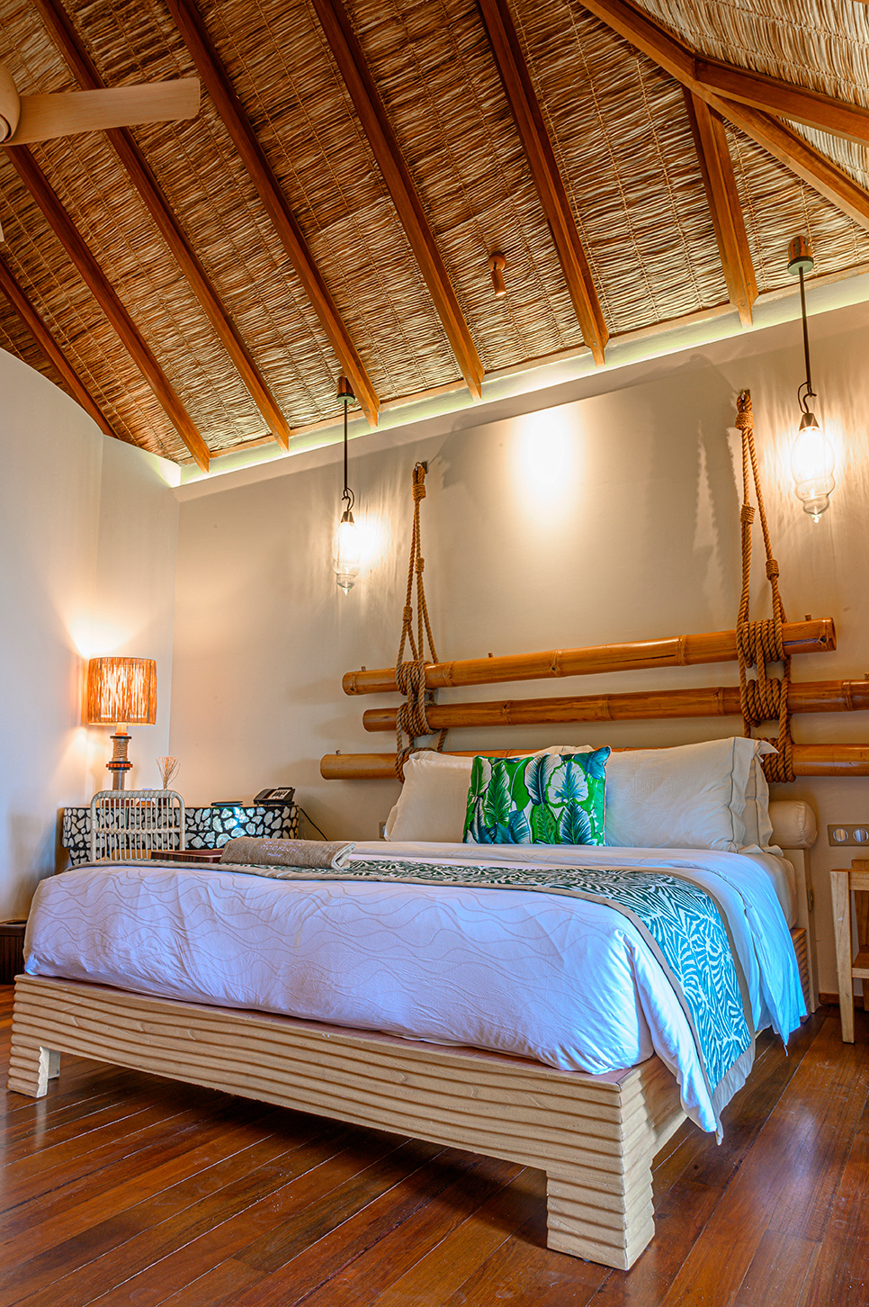 Cozy bedroom with natural wood decor at Constance Moofushi