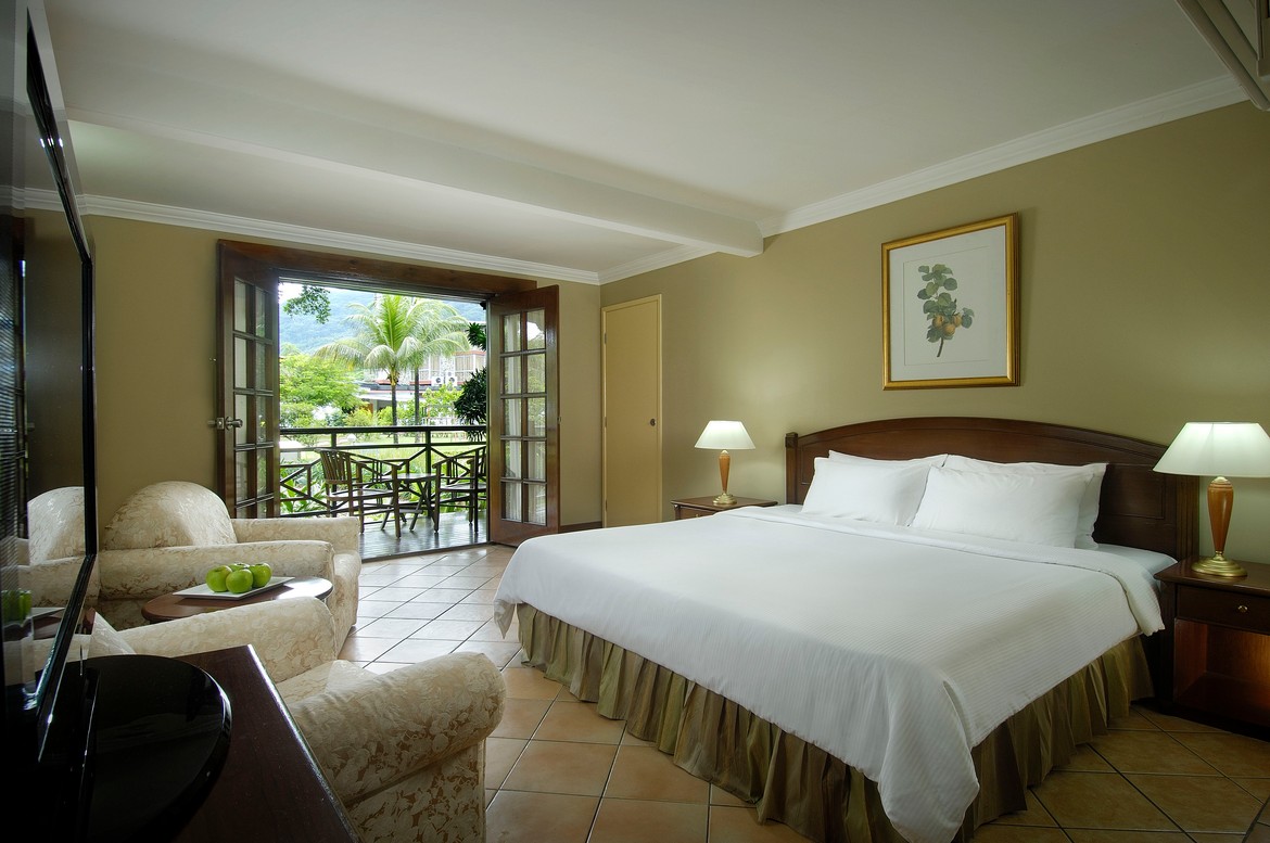 Cozy hotel room with balcony access at Berjaya Beau Vallon