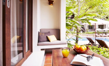 Cozy patio area with fruit and a book at The Tubkaak Krabi resort