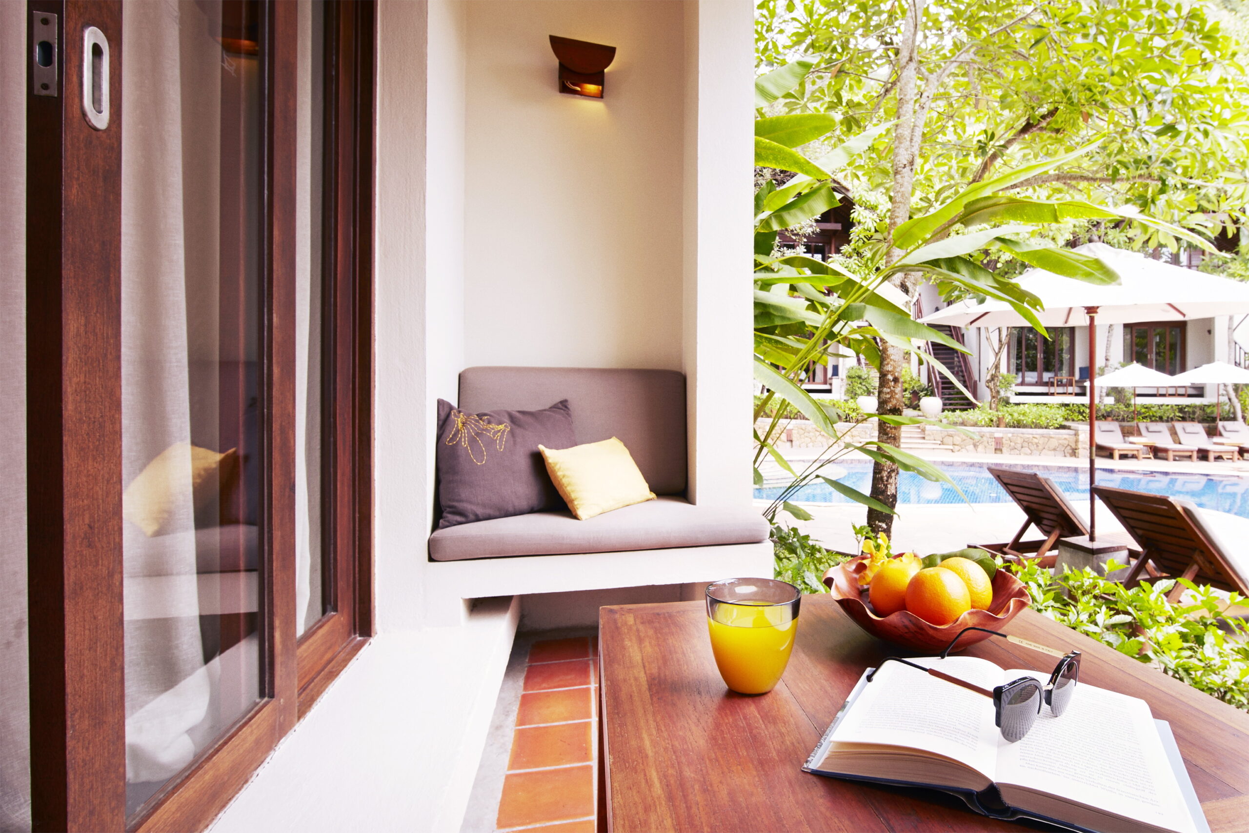 Cozy patio area with fruit and a book at The Tubkaak Krabi resort