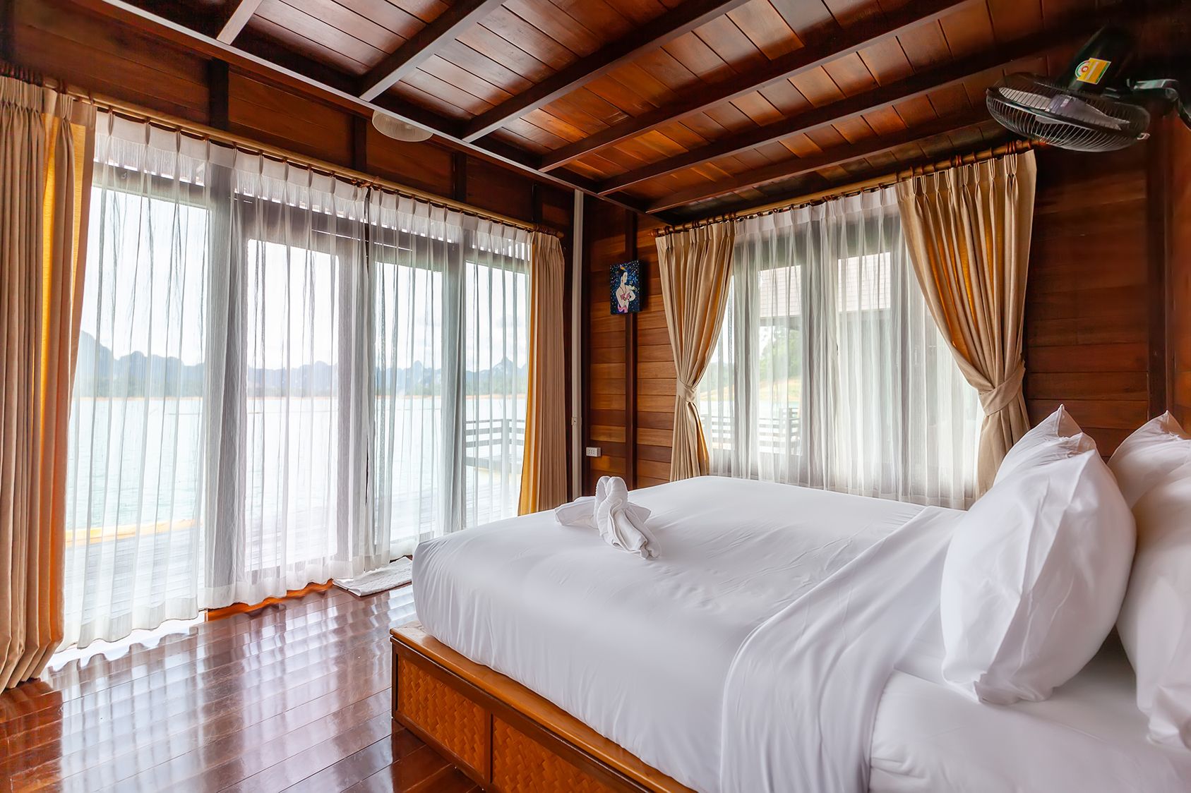 Cozy villa interior with large windows offering lake views at 500Rai Floating Resort