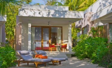 Dhigali beachfront villa with sun loungers and tropical garden