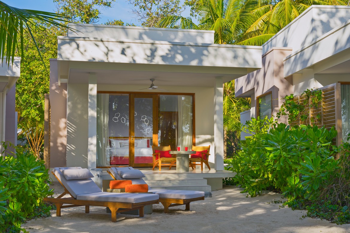 Dhigali beachfront villa with sun loungers and tropical garden