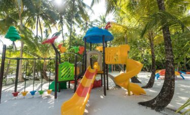 Dhigali vibrant childrens playground under palm trees