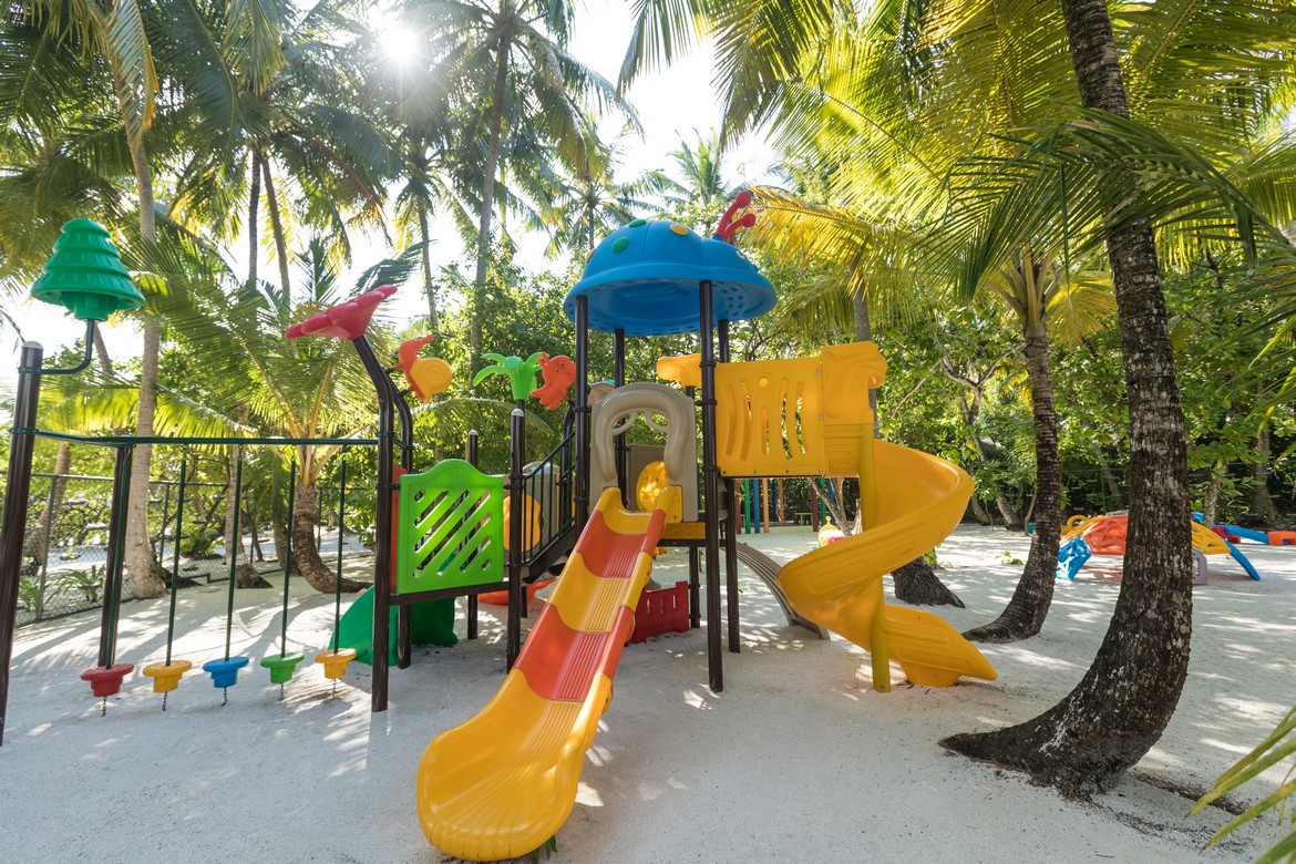 Dhigali vibrant childrens playground under palm trees