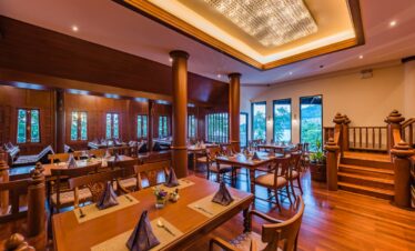 Elegant dining room with wooden interiors at Diamond Cliff Resort with evening ambiance