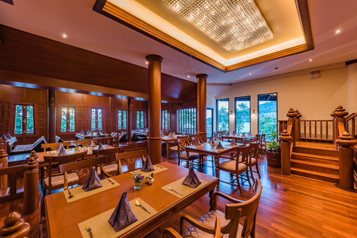 Elegant dining room with wooden interiors at Diamond Cliff Resort with evening ambiance